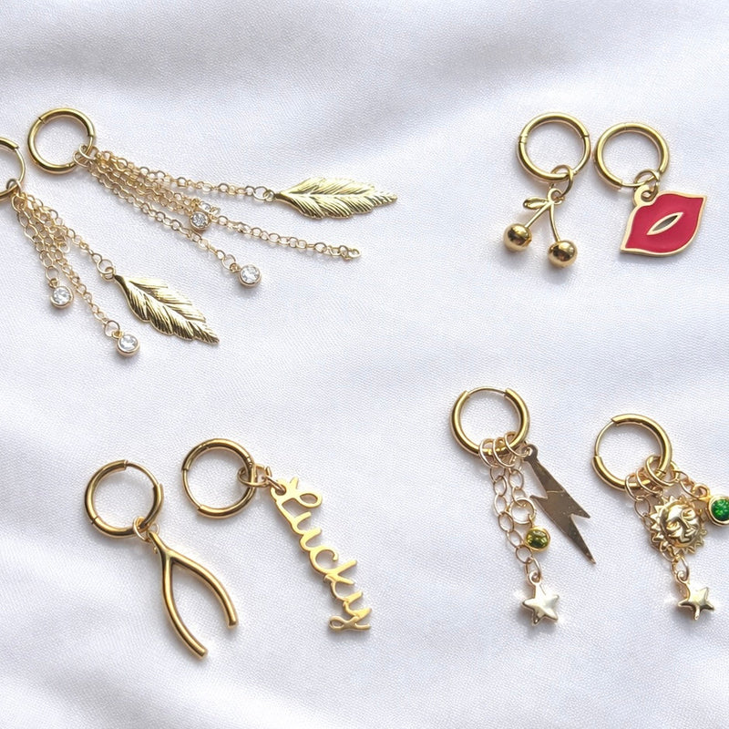 Collection of gold charm earrings