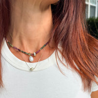 Lifestyle photo of Riviera Romance tourmaline choker worn with white t-shirt showing elegant layering style with rainbow gemstone beads and pearl pendant - boho chic jewelry