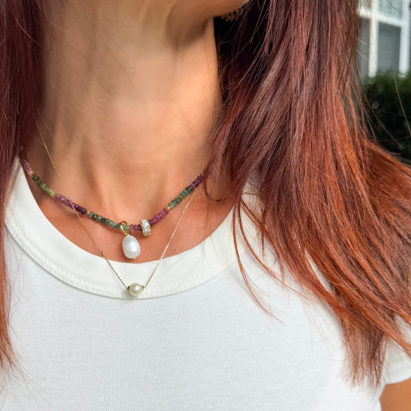 Lifestyle photo of Riviera Romance tourmaline choker worn with white t-shirt showing elegant layering style with rainbow gemstone beads and pearl pendant - boho chic jewelry