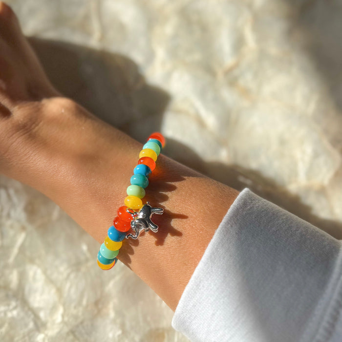 Happy Elephant 7 inch beaded bracelet worn on wrist showing vibrant rainbow colors and cute elephant charm pendant