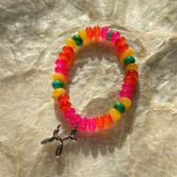 Carnival Candy 7 inch stretch bracelet with multicolored translucent beads pink orange yellow green blue and silver balloon animal charm on marble surface