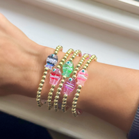 Fish bracelets on an woman’s arm