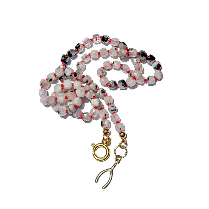 Natural moonstone necklace with gold filled clasp and wishbone charm on white background