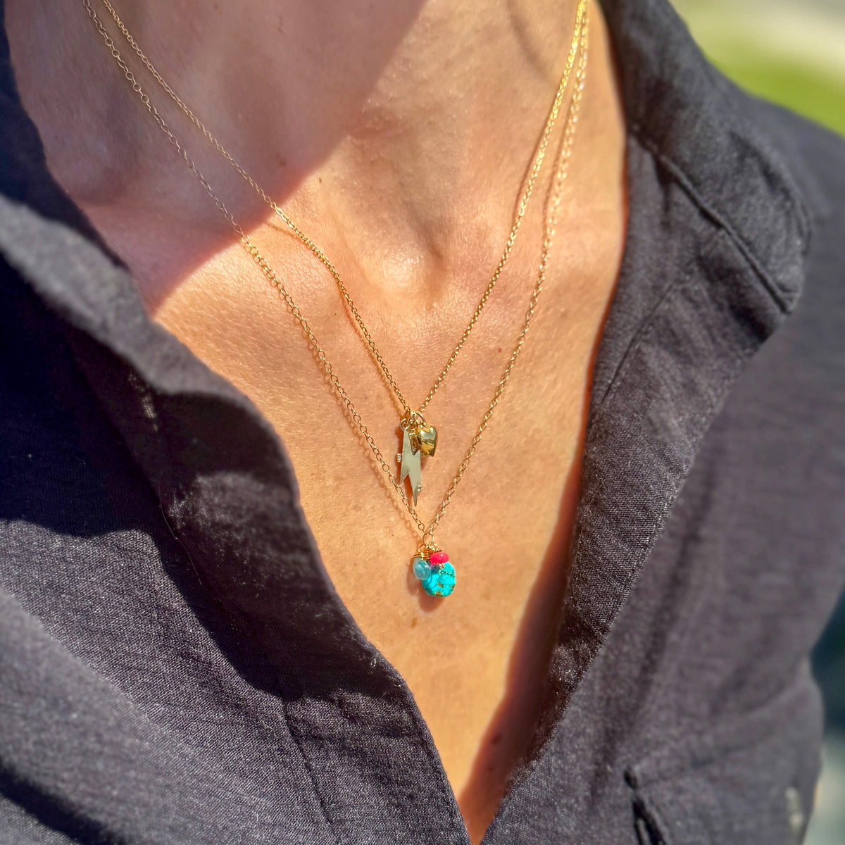 Gold Christian charm necklace with cross, heart and lightning bolt charms 