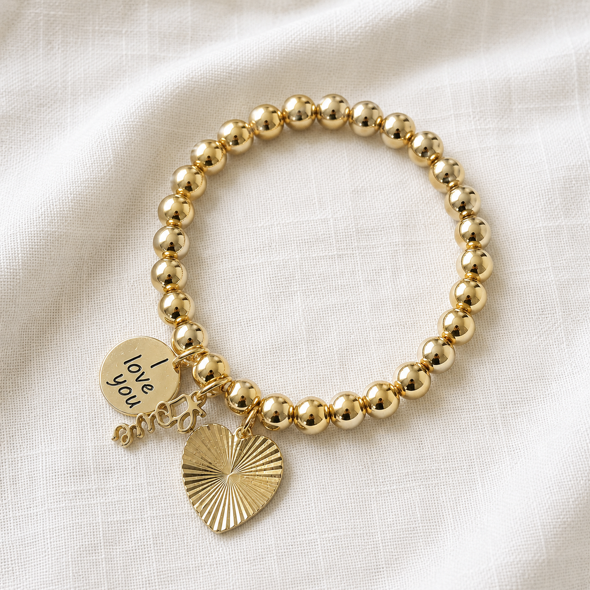 Gold tone hematite stretch bracelet with sunburst heart charm, Love script charm, and I love you engraved disc — one of a kind handmade bracelet by Shop Lucky Charms