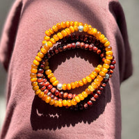 A stack of Men’s tigers eye bracelets 