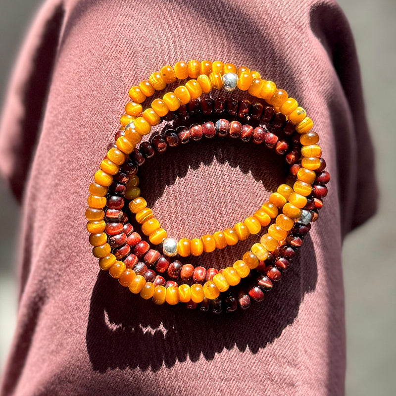 A stack of Men’s tigers eye bracelets 