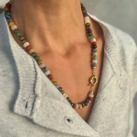 Close up of Terra Tapestry beaded necklace with gold filled clasp featuring hand knotted tigers eye jade jasper and sodalite stones