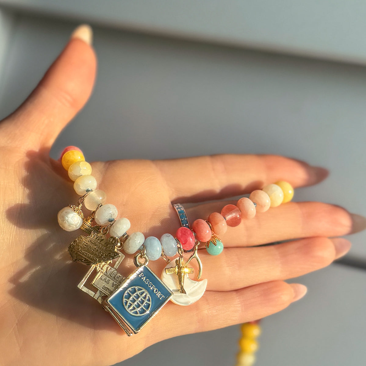 Beaded charm necklace with travel related charms 